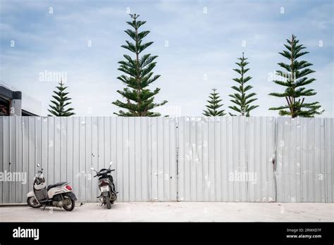 A corrugated metal wall erected in-front of the beach along Walking ...