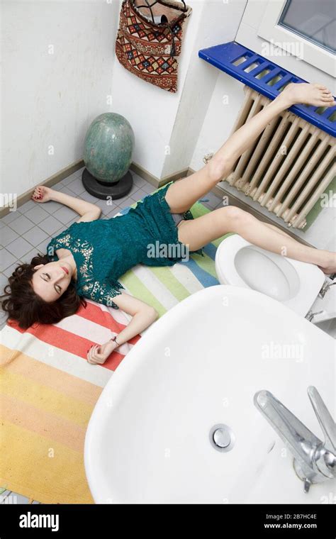 Young woman lying in the bathroom after a bad fall, typical domestic ...