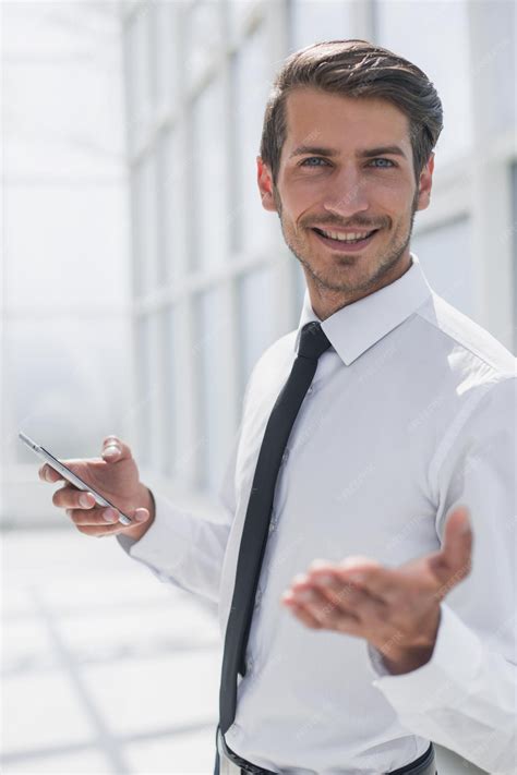 Premium Photo Close Upsmiling Businessman With Smartphone