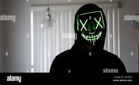 A terrifying slasher killer in a scary horror halloween mask pulling a Stock Video Footage - Alamy