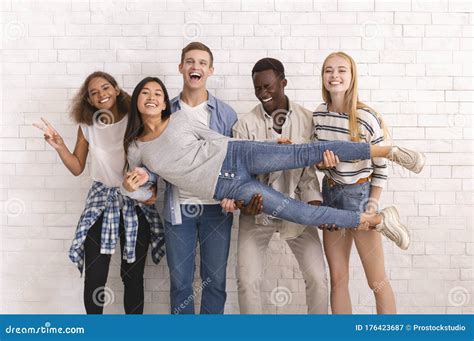 Joyful International Group of Friends Posing Over White Wall Stock ...