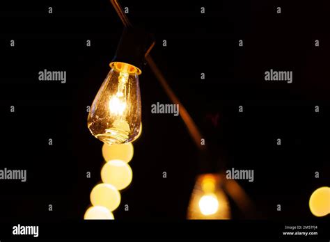 Hanging Lit Light Bulb Black Background Stock Photo Alamy