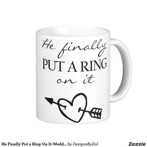 A White Coffee Mug With The Words He Finally Put A Ring On It And An Arrow