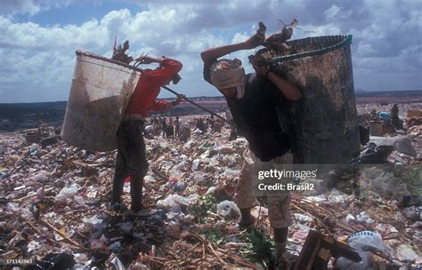 Two Workers Sifting Through Litter At A Landfill High Res Stock Photo