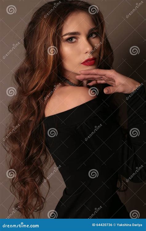 Beautiful Woman With Long Dark Curly Hair Wears Elegant Dress Stock