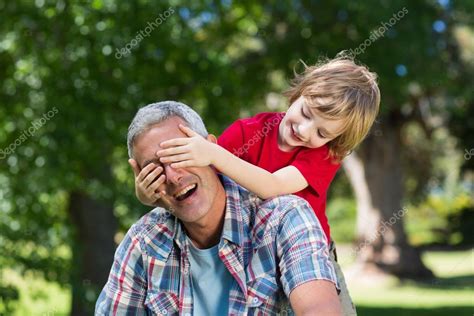 Boy Hiding His Fathers Eyes With Hands — Stock Photo © Wavebreakmedia