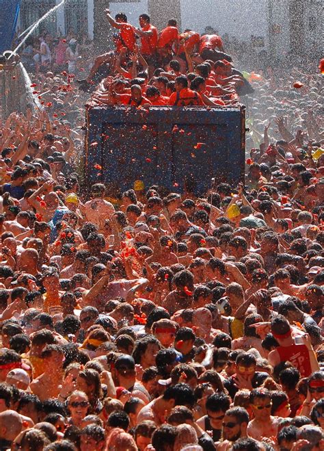 Thousands Of Revelers Paint The Town Red At The Annual La Tomatina