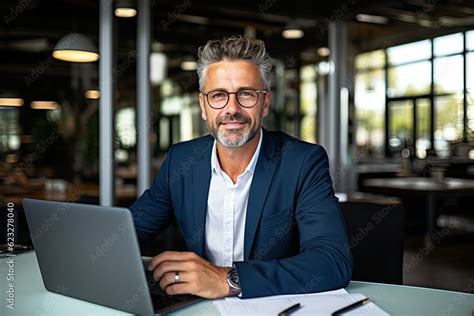 Smiling Mature Adult Business Man Executive Sitting At Desk Using