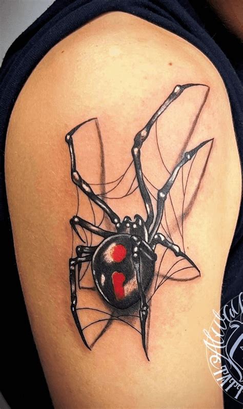 A Black And Red Spider Tattoo On The Back Of A Womans Shoulder