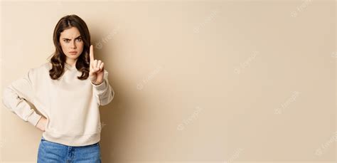 Premium Photo Serious Woman Show One Finger Stop Disapproval Sign