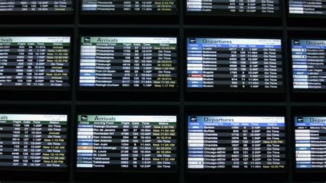 Airport Timetable Arrivals And Departures Board With Changing Flight