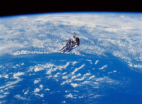 Astronaut Floating In Space Wallpaper | Denaro Wallpapers