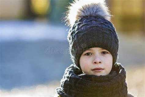 Portrait Of Child Boy In Hat And Scarf Outdoors In Sunny Winter Stock