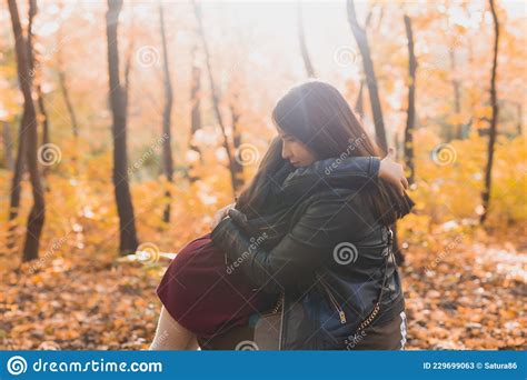 Mother And Daughter Spend Time Together In Autumn Yellow Park Season