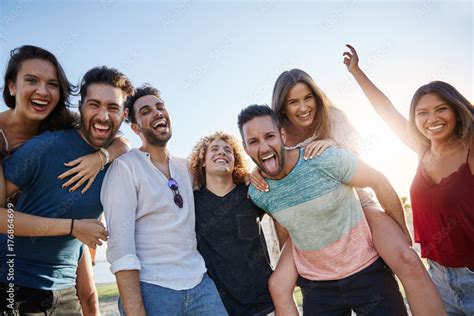 Group Of Young Happy People Standing Together Outside Stock Photo