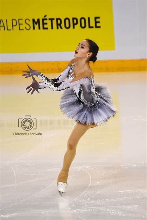 A Female Figure Skating On An Ice Rink