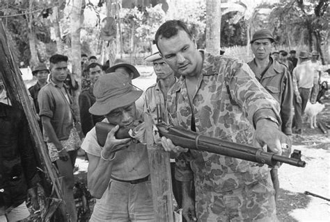 An American Military Advisor Training A Montagnard Indigenous Person