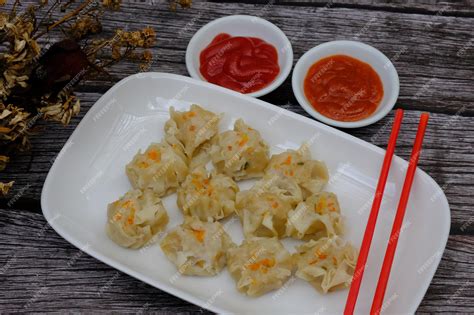 Premium Photo | Siomay on a white ceramic plate. tomato sauce. chili ...