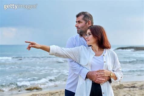 Outdoor Portrait Of Mature Couple Hugging On The Seashore