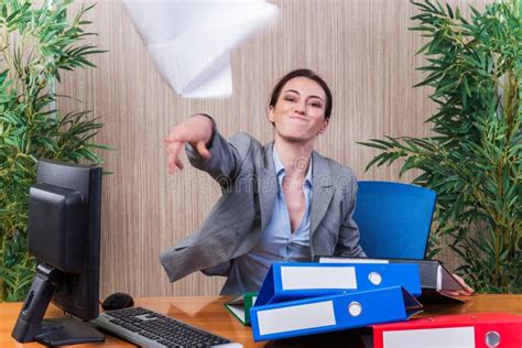 The Woman Throwing Papers In The Office Under Stress Stock Image