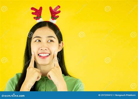 Smiling Young Asian Woman Wears A Reindeer Headband For Christmas Party