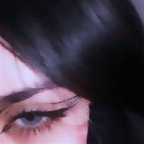 A Woman S Eye With Long Lashes And Black Hair Is Seen Through The