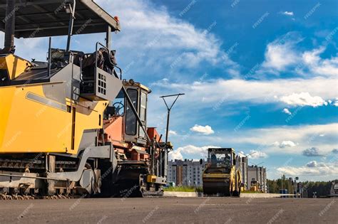 Premium Photo | Asphalt laying equipment work on the device of a new ...