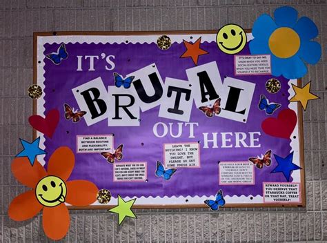 A Bulletin Board That Has Been Decorated With Colorful Paper Flowers