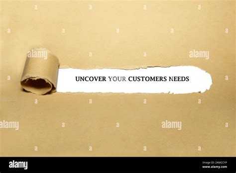 Text Uncover Your Customer Needs Appearing Behind Torn Paper Concept