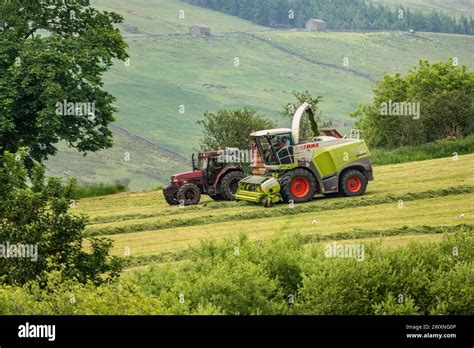 Tractors Pulling Wagons Of Haylage England Stock Photo Alamy