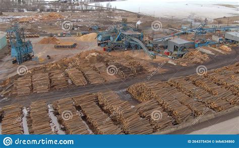 AERIAL Flying Above A Sawmill Storage Area Full Of Big Piles Of Tree