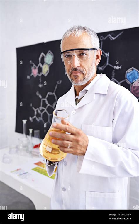 Unraveling Chemistry Portrait Of A Mature Male Scientist Doing A