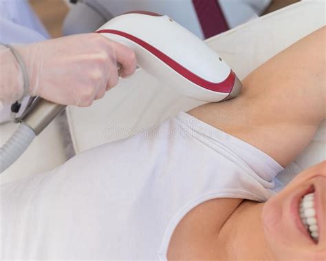 Doctor Doing Laser Hair Removal On A Woman X S Armpit In The Salon