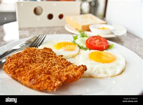 Breakfast with fried eggs, toast, and fried fish Stock Photo - Alamy