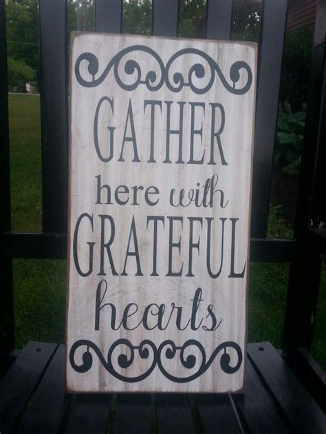 A Wooden Sign That Says Gather Here With Grateful Hearts