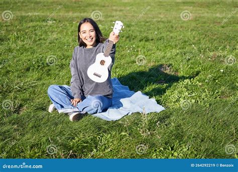 Music And Instruments Portrait Of Cute Asian Girl Shows Her White