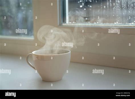 Cup Of Hot Drink Near Window On Rainy Day Space For Text Stock Photo Alamy