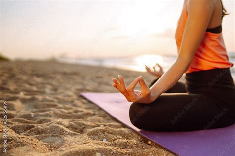 Meditation. Young woman doing yoga near the ocean barefoot. Calmness and balance, a healthy ...