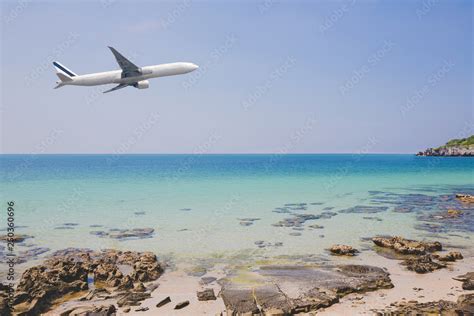 Airplane Flying Over Beach