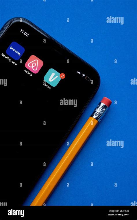 Iphone with vinted app icon on screen next to booking.com amd airbnb ...