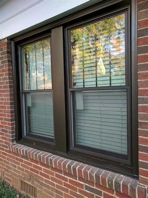 Bronze Double Hung Windows With Vertical Grids In Top Sashes And Bronze