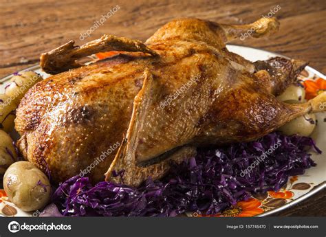 Roast duck with potatoes and purple cabbage Stock Photo by ©Paulovilela 157745470