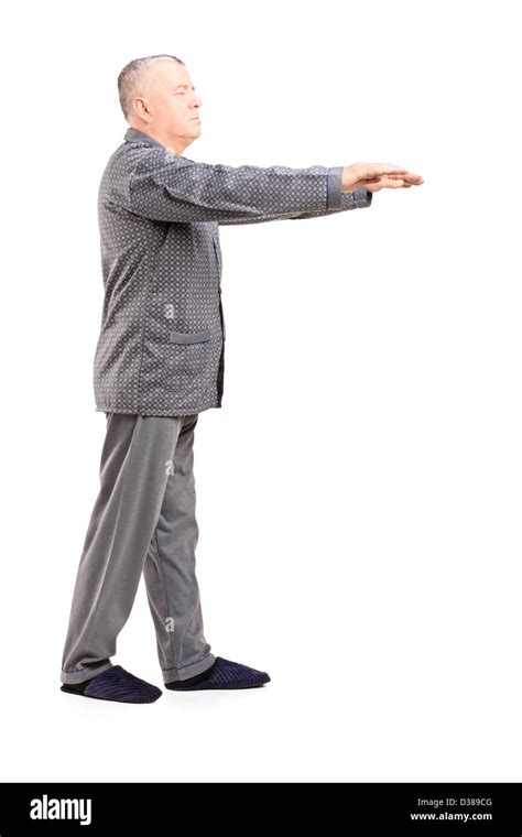 Full Length Portrait Of A Mature Man In Pajamas Sleepwalking Isolated