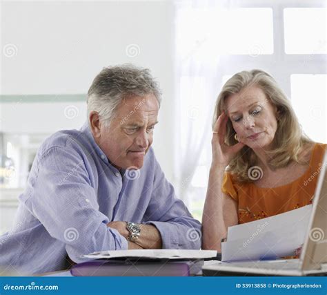 Worried Mature Man Collecting Water Leaking From Ceiling While His Wife Calling Plumber Royalty
