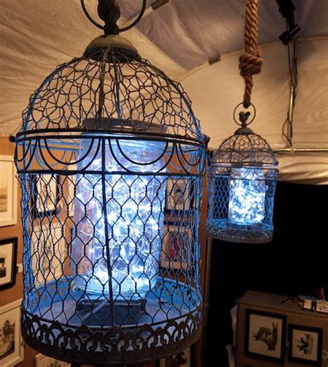 Two Bird Cages Hanging From The Ceiling In A Room