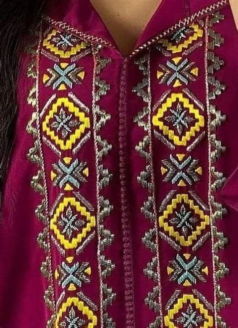 A Close Up Of A Woman S Shirt With An Embroidered Design On The Chest