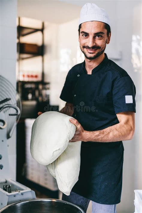 Italian Chef Pizzaiolo Preparing Pizza Dough In Restaurant Kitchen