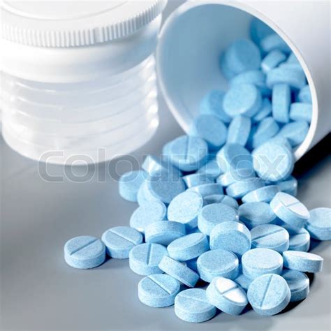 Blue pills fallen out of the box | Stock image | Colourbox