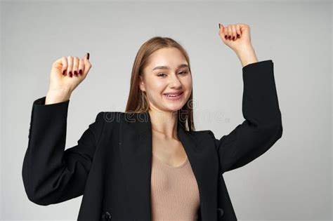 Young Woman Standing With Her Arms Lifted High Above Her Head Expressing Joy And Triumph Stock