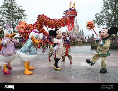 Shanghai, China. 11th Jan, 2017. Cartoon characters join in the Chinese traditional dragon dance ...